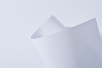 close up view of curved paper sheet isolated on white