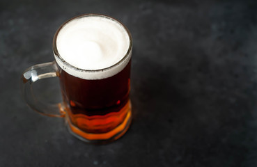 glass of beer on stone background with copy space for your text