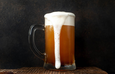 fresh beer in a beer glass on a stone background
