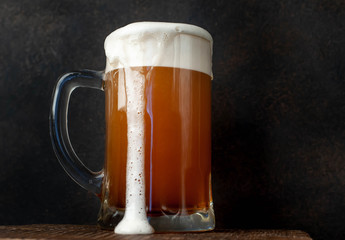 fresh beer in a beer glass on a stone background
