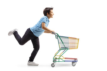 Boy running and pushing a small shopping cart © Ljupco Smokovski