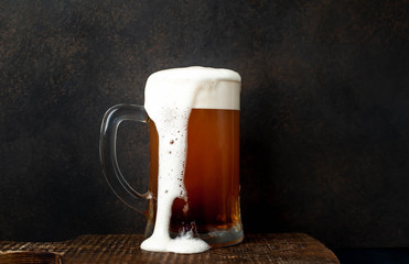 fresh beer in a beer glass on a stone background
