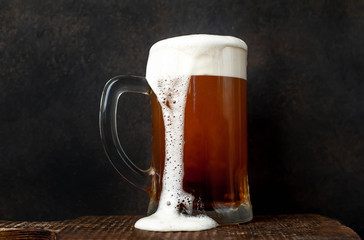 fresh beer in a beer glass on a stone background
