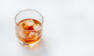 glass with whiskey on a white background
