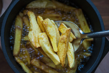 Photo of homemade fries drawn from cooking oil, top view
