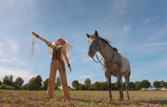 An young Indian girl is seen in a crop field with 
her horse. Her unhappy face reveals that the land is 
drying out due to global warming effects.