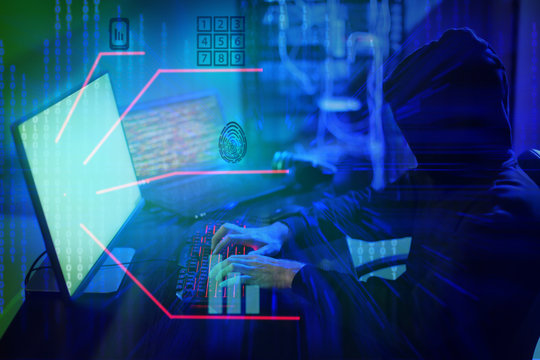 Professional hacker using computer in dark room