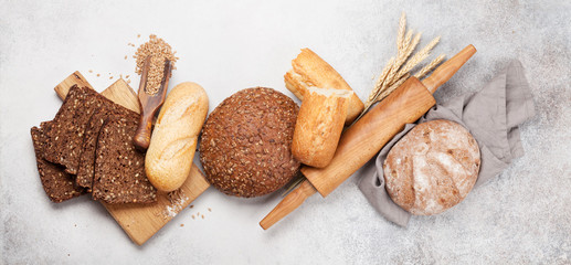 Various bread with wheat, flour and cooking utensils