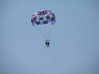 Parasailing water amusement. couple of men and women on a paraglider