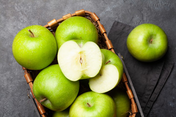 Ripe green apple fruits on dark stone table