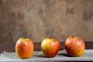 natural and healthy tropical fruit apple on the table on blurred texture background