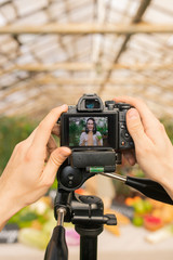 Obraz premium Close-up of unrecognizable camera operator preparing for shooting video review on farm products