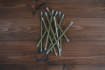 Simple pencils with an eraser on brown boards.