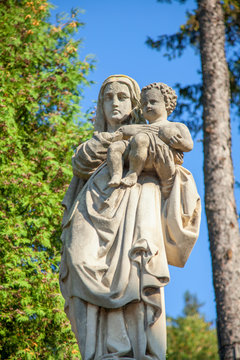 Ancient stone statue of Virgin Mary with Jesus Christ. Religion, faith, love, Christianity concept.