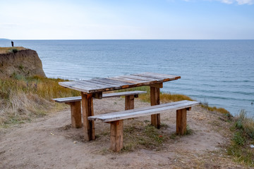 Fototapeta na wymiar table and benches by the sea. A place to sit and relax.