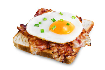Fried egg fried bacon sandwich on a white isolated background