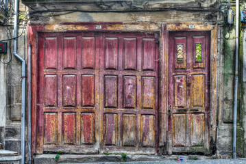 Red, old and abandoned garage door in Porto, Portugal shoot on June 25th, 2019 