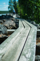 Duckboard near the wild river "Mårdseleforsen" in northern Sweden. Summertime hike.