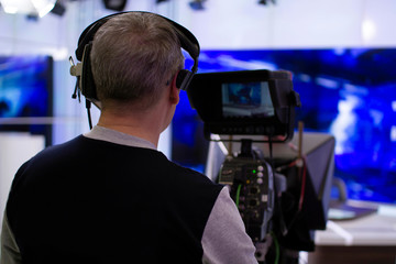 Professional cameraman working in a TV Studio.