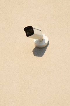 security surveillance camera on beige wall