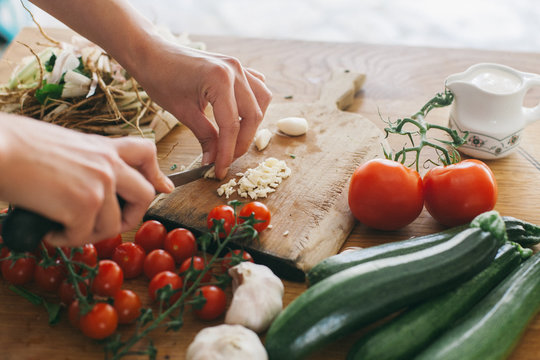 Woman preparing lunch on a wooden kitchen table