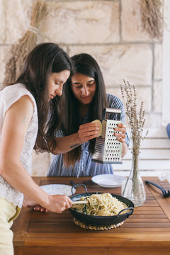 Female friends preparing a Mediterranean style lunch