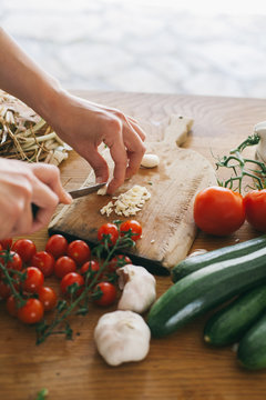 Woman preparing lunch on a wooden kitchen table