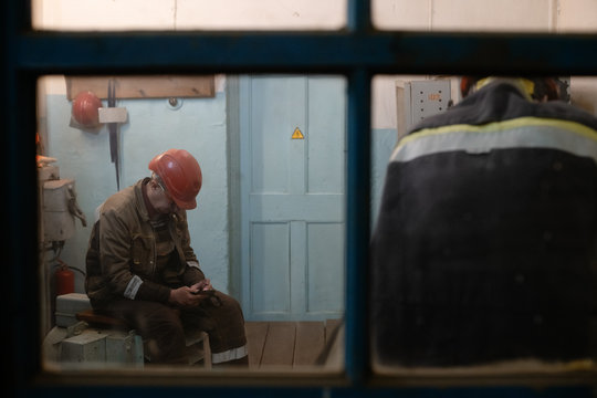 Factory worker using smartphone during break