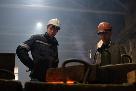 Foundry employees working with mold