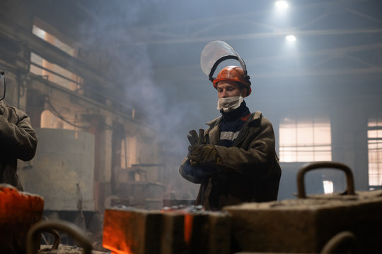 Worker putting on gloves in workshop