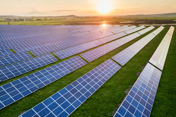 Blue solar photo voltaic panels system producing renewable clean energy on rural landscape and...