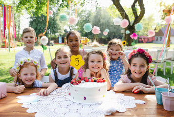 Kids birthday party outdoors in garden in summer, celebration concept.