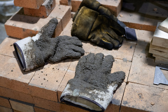 Dirty gloves on stack of bricks