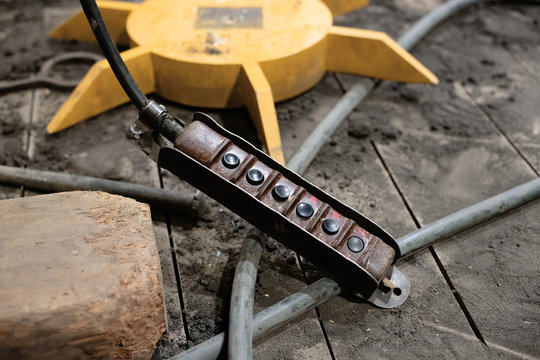 Weathered control box on dirty factory floor