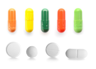 Set of different pills on white background