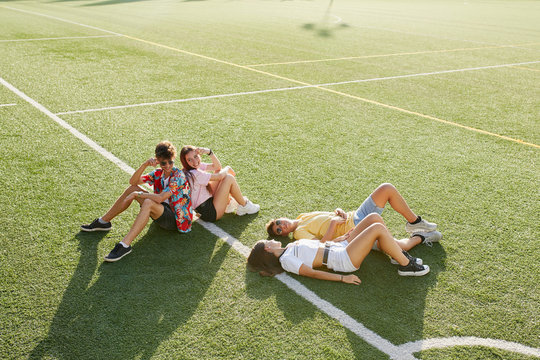 Teenagers relaxing on the grass field