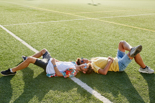 Teenagers relaxing on the grass field