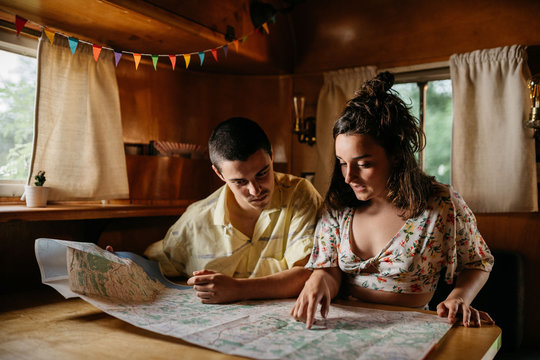 Couple reading map in camper