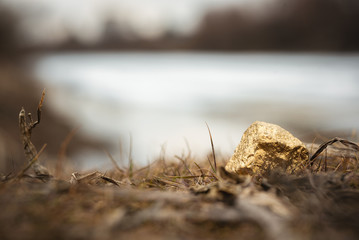 Golden ore on the ground close up concept.