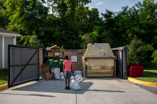 Pre Teen taking out garbage