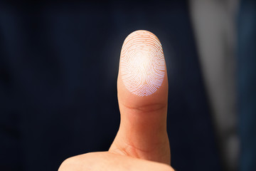 Businessman using fingerprint protection for data access, closeup