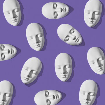 White plaster masks in pattern layout