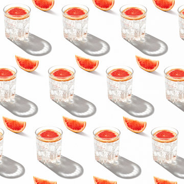 Close up of cocktail glasses with grapefruit slices on table