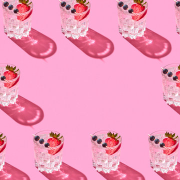 Pattern of glasses with water and berries