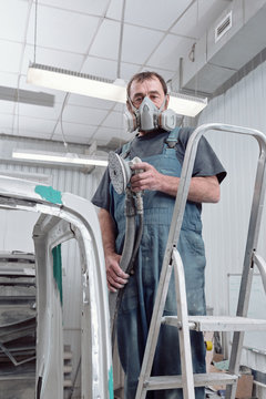 Car Painter Wearing Respirator Looking At Camera