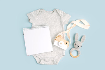 Gray cute baby bodysuit with mock up card. Set of kids clothes and accessories. Fashion newborn....
