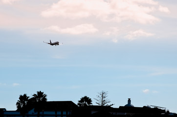 plane flies over the roof of a house in the city of Porto in Portugal, bottom view. plane crash over the city, bottom view