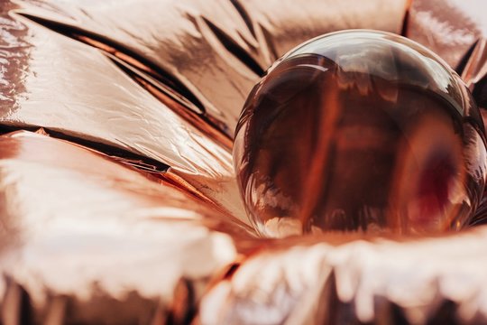 Pink gold or copper and crystal ball abstract shot