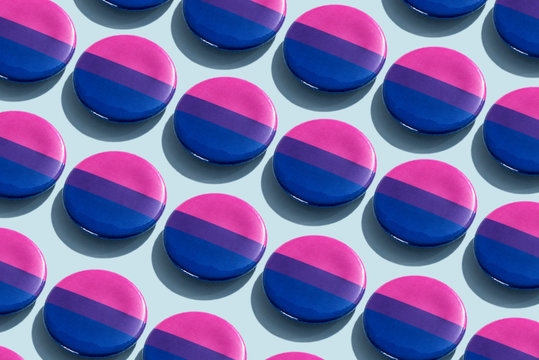 Close Up Of Bisexual Pride Flag Badges On Table