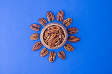 Pekan nut close-up on a classic blue background.